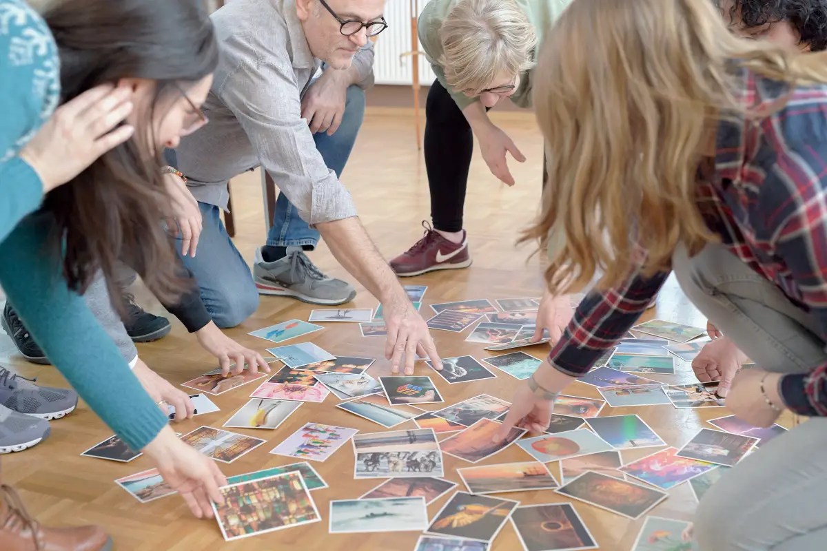 A group exploring coaching cards together in a workshop